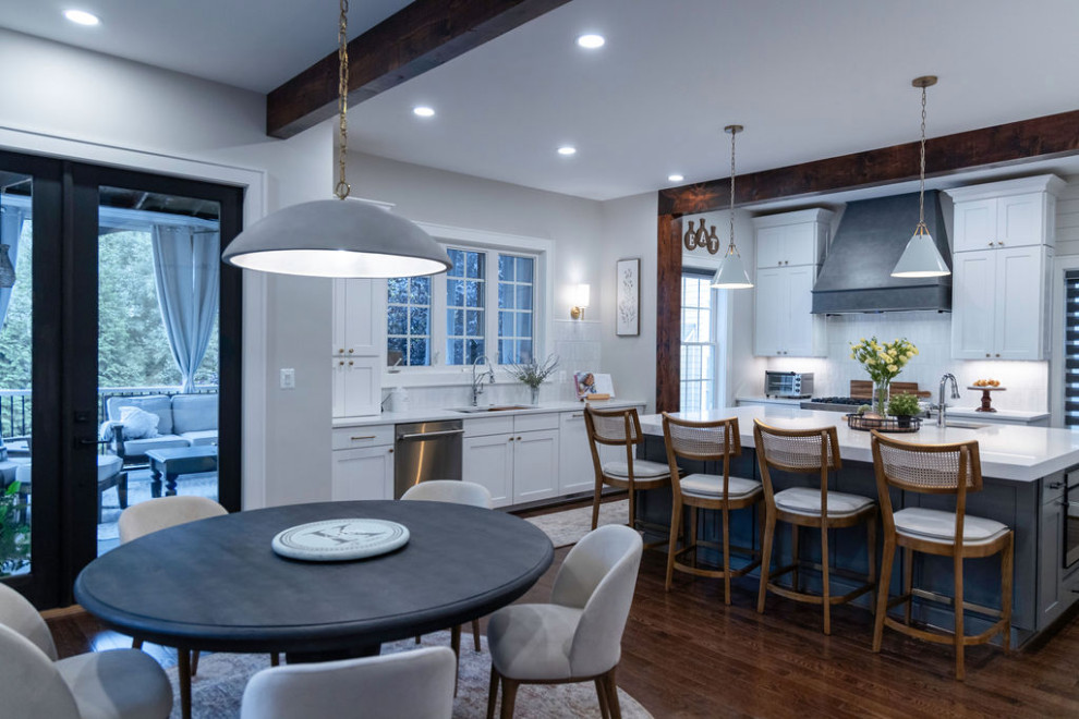 Large transitional u-shaped medium tone wood floor kitchen photo in DC Metro with a single-bowl sink, flat-panel cabinets, quartz countertops, white backsplash, porcelain backsplash, stainless steel appliances, an island and white countertops