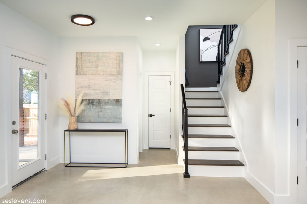 Small classic foyer with white walls, concrete flooring, a single front door, a white front door and beige floors.