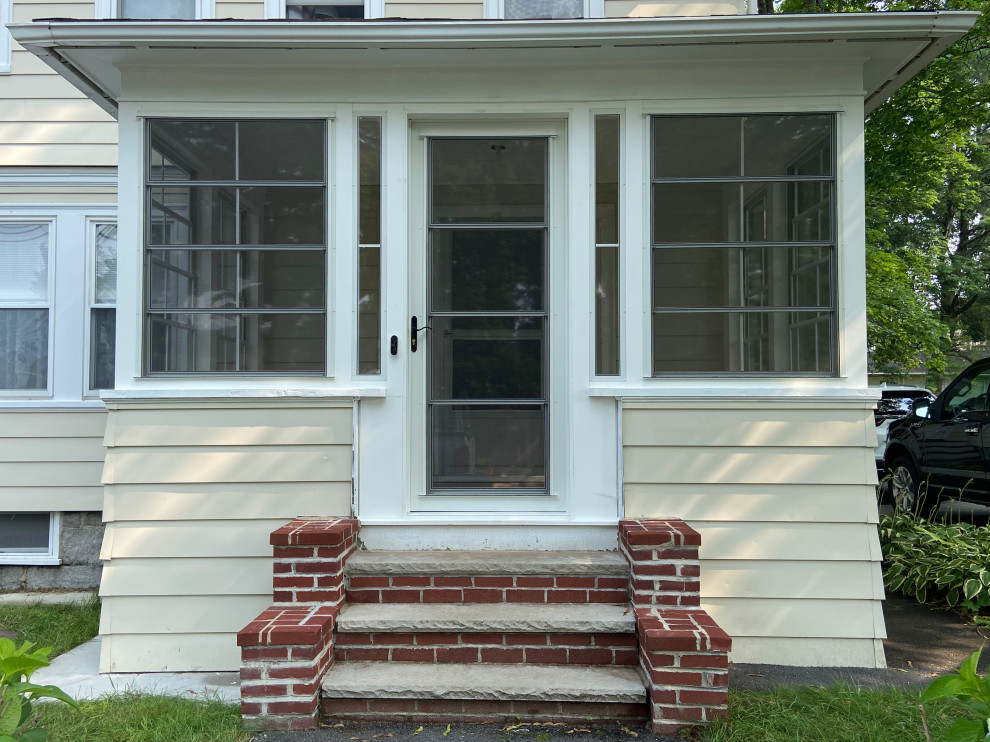 Small elegant screened-in front porch photo in Boston