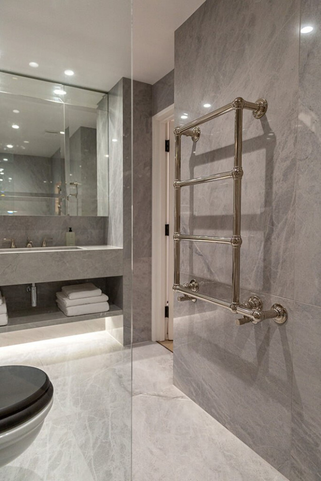This is an example of a large modern grey and white shower room bathroom in London with open cabinets, a floating vanity unit, grey cabinets, a built-in bath, a shower/bath combination, an urinal, grey tiles, glass tiles, grey walls, ceramic flooring, a built-in sink, stainless steel worktops, grey floors, a hinged door, brown worktops, feature lighting, a single sink, a wallpapered ceiling and wainscoting.