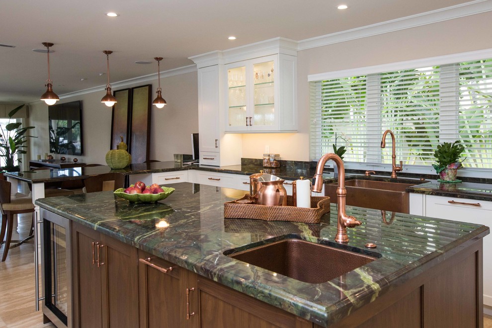 Open concept kitchen - large transitional u-shaped light wood floor open concept kitchen idea in Miami with a farmhouse sink, shaker cabinets, stainless steel appliances, an island, white cabinets, granite countertops, metallic backsplash and mosaic tile backsplash
