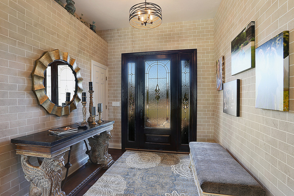 Mountain style dark wood floor single front door photo with beige walls and a black front door