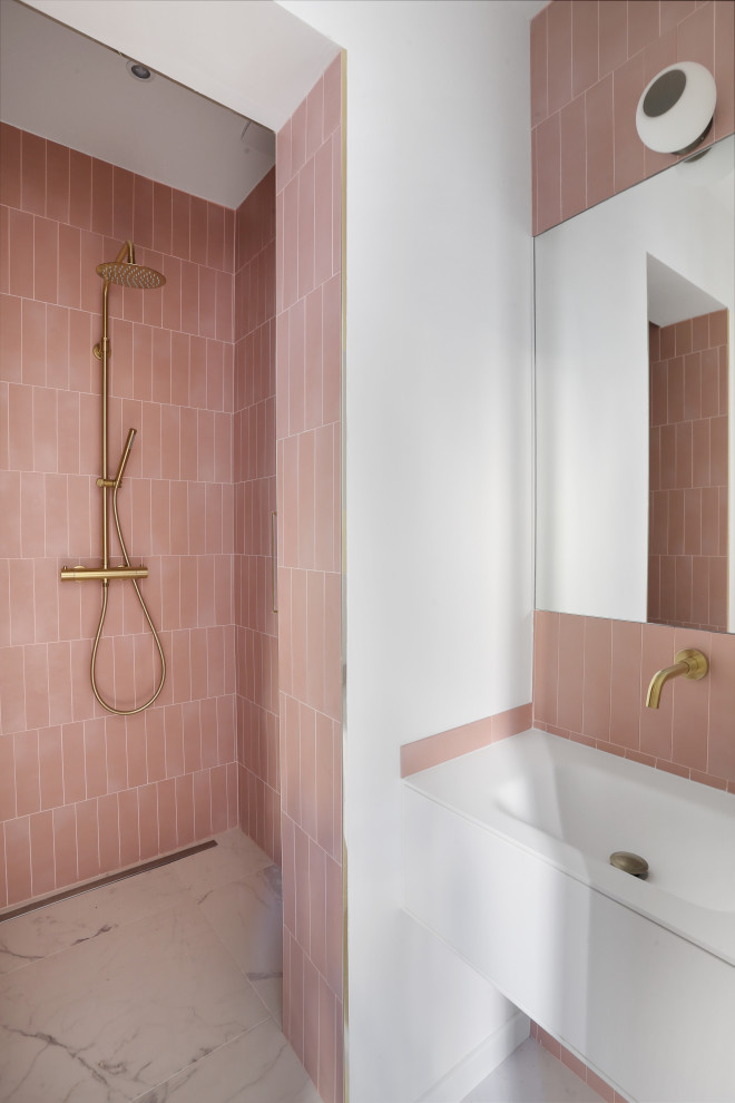 This is an example of a small contemporary family bathroom in Paris with beaded cabinets, a single sink, a floating vanity unit, white cabinets, an alcove bath, pink tiles, ceramic tiles, pink walls, a console sink, white floors, an open shower, white worktops and a shower bench.