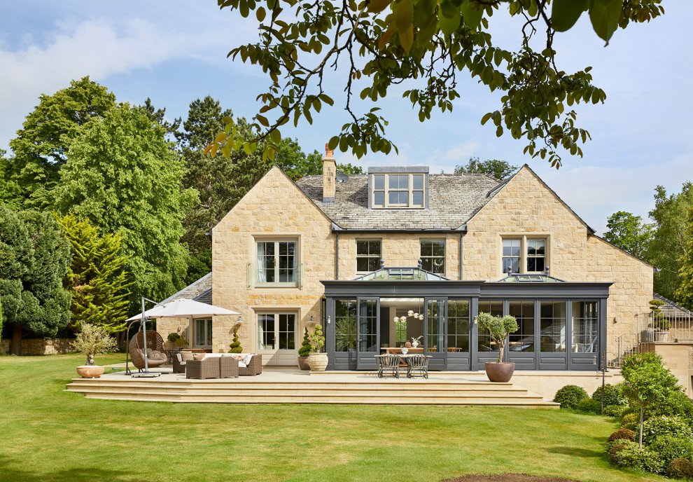 Design ideas for a beige classic two floor detached house in Essex with stone cladding, a pitched roof and a grey roof.
