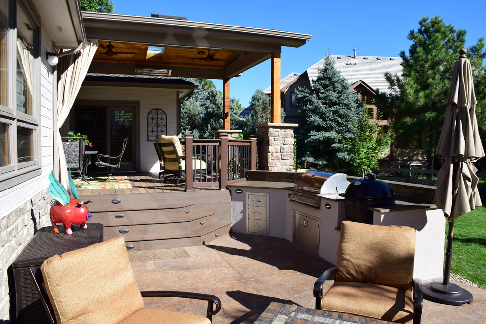 Design ideas for a mid-sized transitional backyard deck in Denver with an outdoor kitchen and a roof extension.
