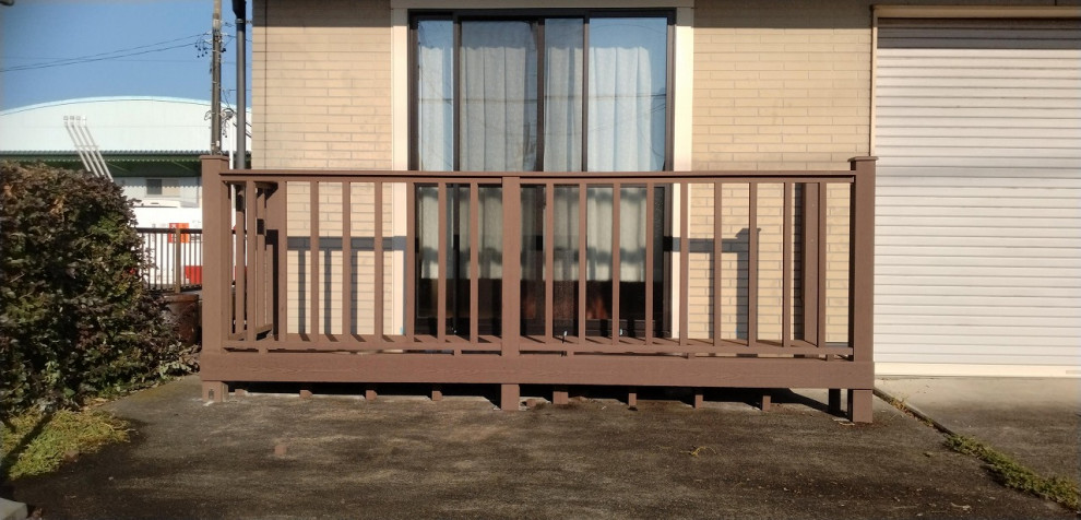 Cette photo montre une terrasse au rez-de-chaussée moderne de taille moyenne avec jupe de finition, une cour, aucune couverture et un garde-corps en bois.