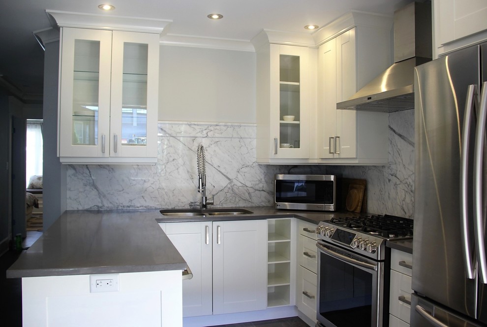 Transitional kitchen photo in Vancouver with shaker cabinets, granite countertops and a peninsula