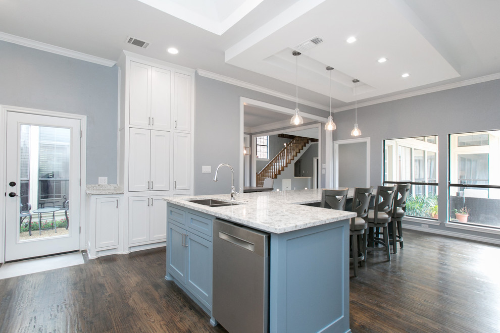 Inspiration for a large transitional u-shaped open plan kitchen in Dallas with a double-bowl sink, shaker cabinets, white cabinets, quartzite benchtops, white splashback, stone slab splashback, stainless steel appliances, dark hardwood floors, with island, brown floor and turquoise benchtop.
