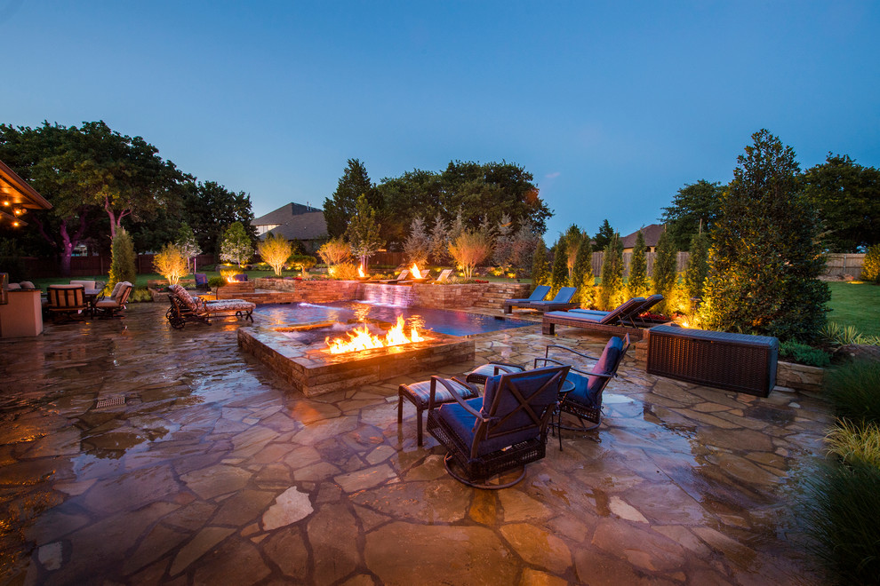Inspiration for a mid-sized modern backyard patio in Oklahoma City with natural stone pavers.