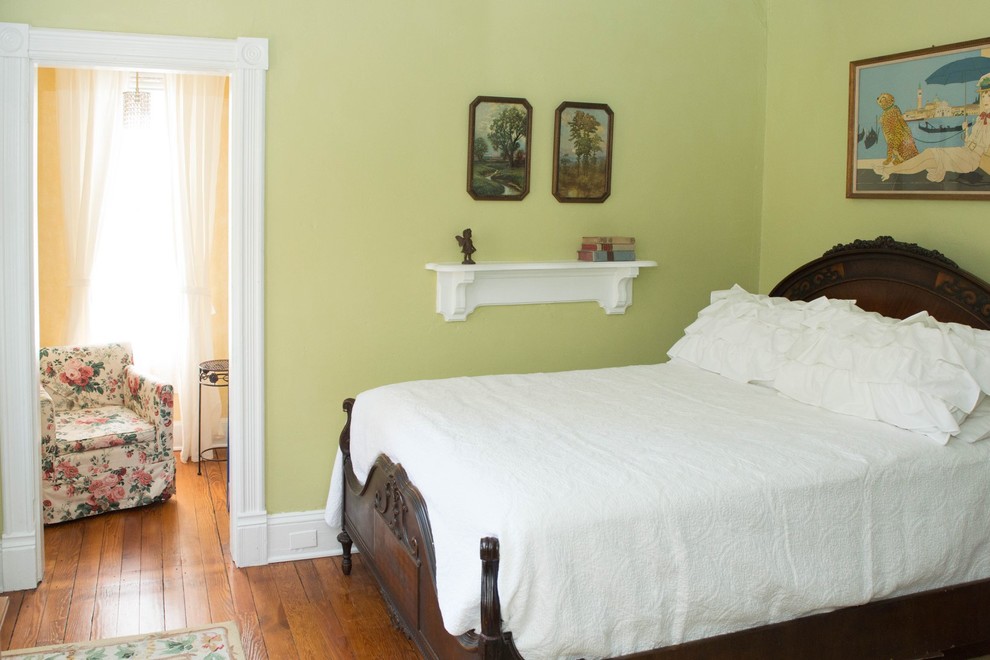 Inspiration for a mid-sized traditional guest bedroom in Baltimore with green walls, medium hardwood floors and brown floor.