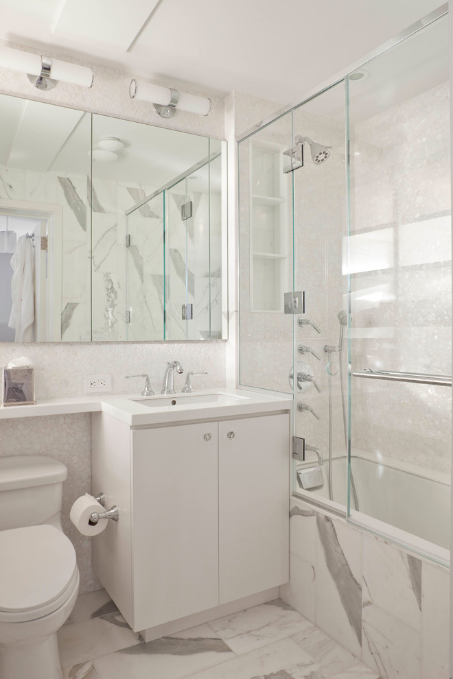 Inspiration for a transitional white tile alcove bathtub remodel in New York with an undermount sink, flat-panel cabinets and white cabinets