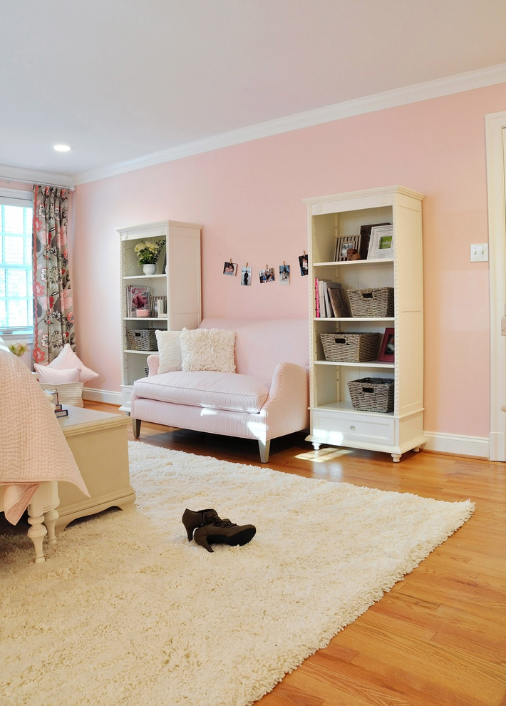 This is an example of a large eclectic bedroom in DC Metro with pink walls, medium hardwood floors and no fireplace.