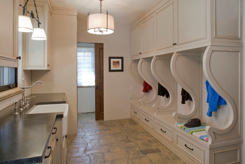 Design ideas for a traditional utility room in Denver with a farmhouse sink, beige cabinets, concrete benchtops, concrete floors and beige floor.