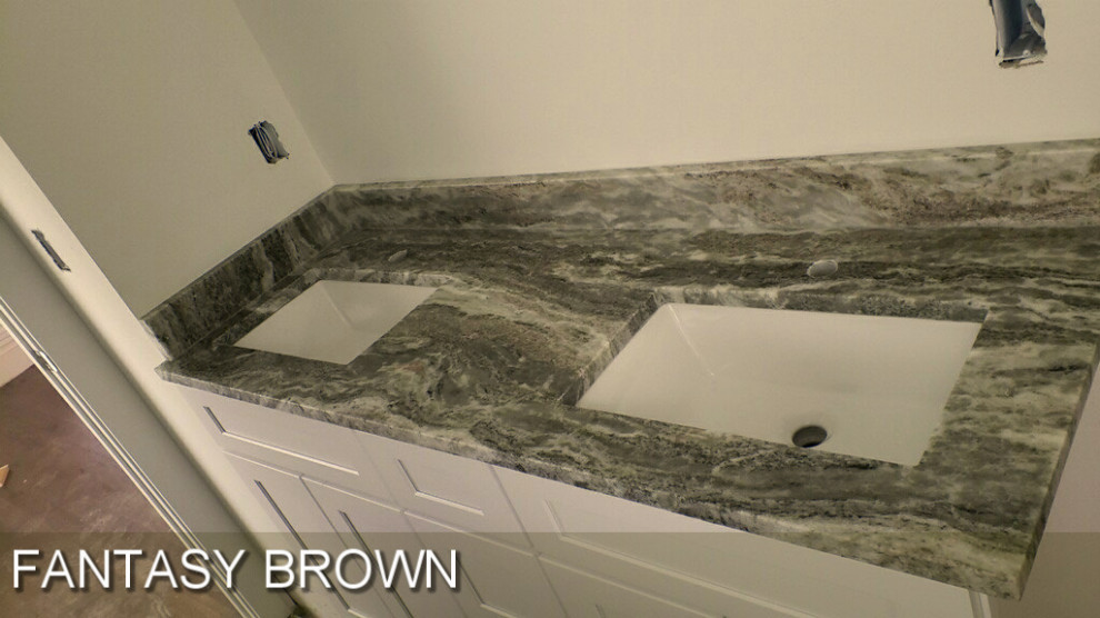 This is an example of a mid-sized modern bathroom in Atlanta with recessed-panel cabinets, white cabinets, a drop-in sink, marble benchtops, brown benchtops and a double vanity.