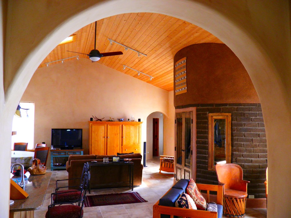 Design ideas for a large open concept living room in Albuquerque with beige walls, travertine floors and a wood stove.