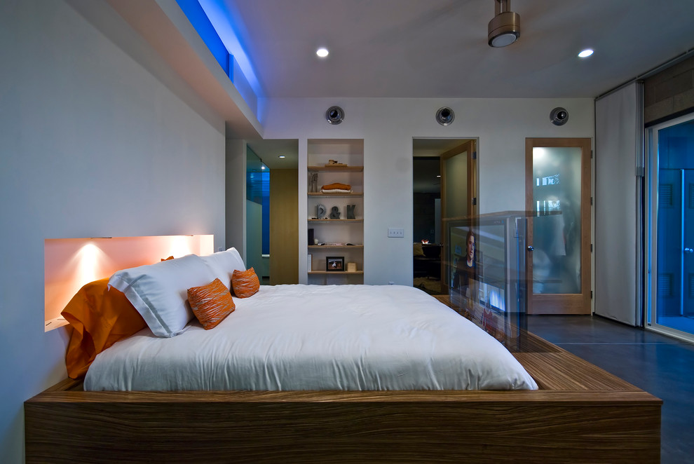 Inspiration for a mid-sized contemporary master bedroom in Phoenix with white walls and concrete floors.