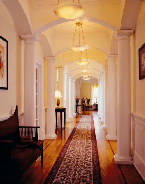 Photo of a large traditional hallway in Boston with beige walls and medium hardwood floors.