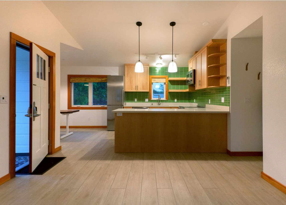 Inspiration for a small traditional u-shaped open plan kitchen in San Francisco with a submerged sink, shaker cabinets, medium wood cabinets, engineered stone countertops, green splashback, ceramic splashback, stainless steel appliances, ceramic flooring, brown floors, white worktops and a vaulted ceiling.
