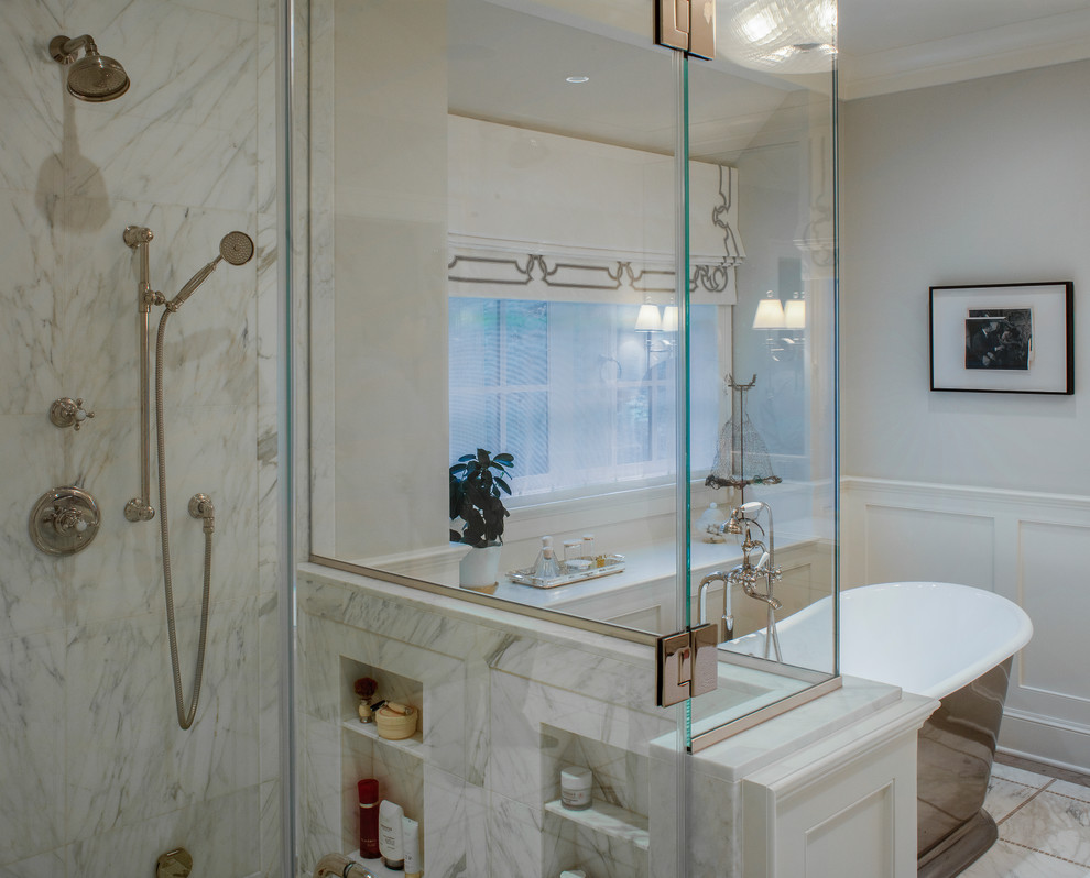 This is an example of a transitional master wet room bathroom in Portland with an alcove tub, grey walls, marble floors, marble benchtops, white floor, a hinged shower door and white benchtops.