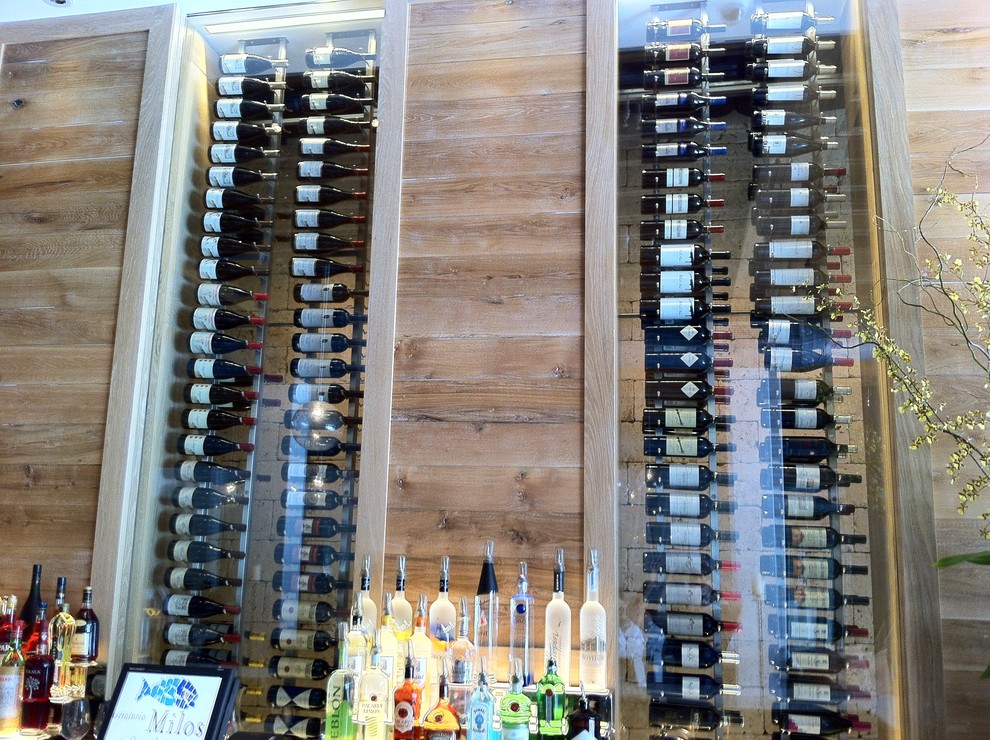 Small modern wine cellar in Miami with display racks.