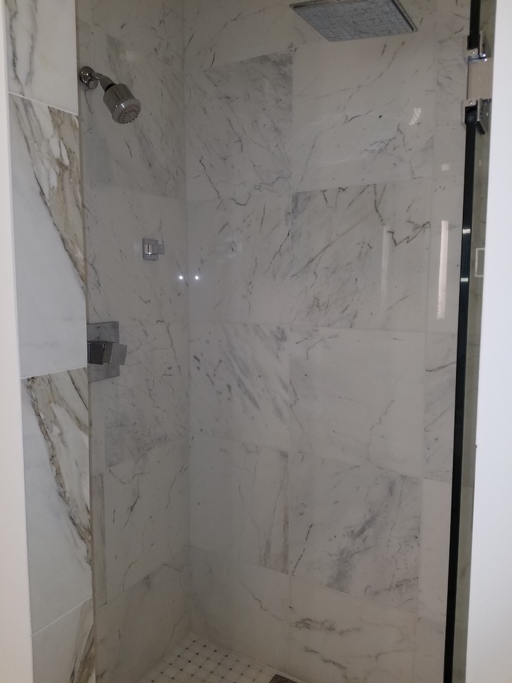 Double shower - small transitional master white tile and marble tile marble floor and white floor double shower idea in Miami with flat-panel cabinets, white cabinets, a one-piece toilet, blue walls, an undermount sink, quartz countertops and a hinged shower door