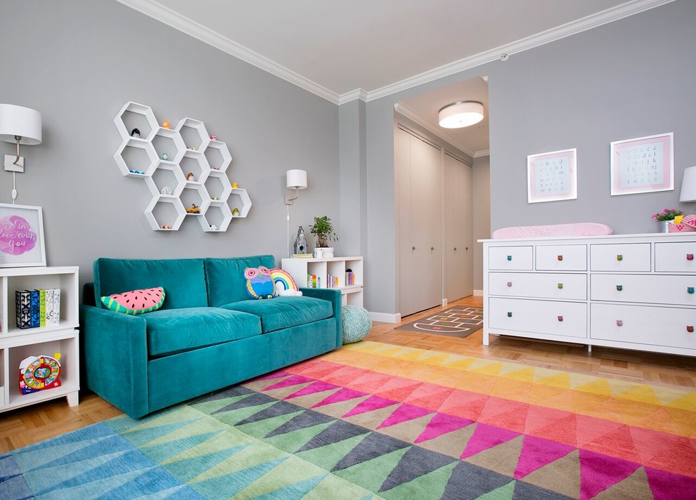 Design ideas for a mid-sized transitional nursery for girls in New York with grey walls and carpet.