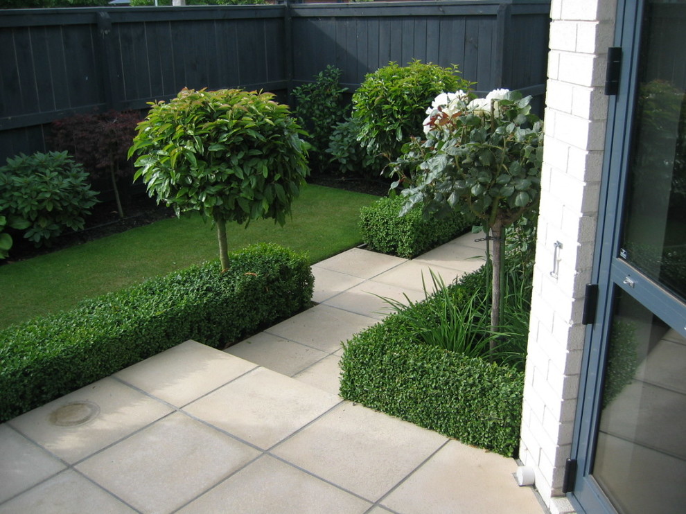 Design ideas for a mid-sized traditional formal garden in Christchurch with a garden path and natural stone pavers.