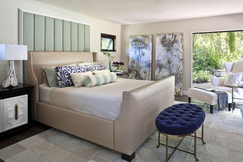 This is an example of a transitional bedroom in Los Angeles with white walls and dark hardwood floors.