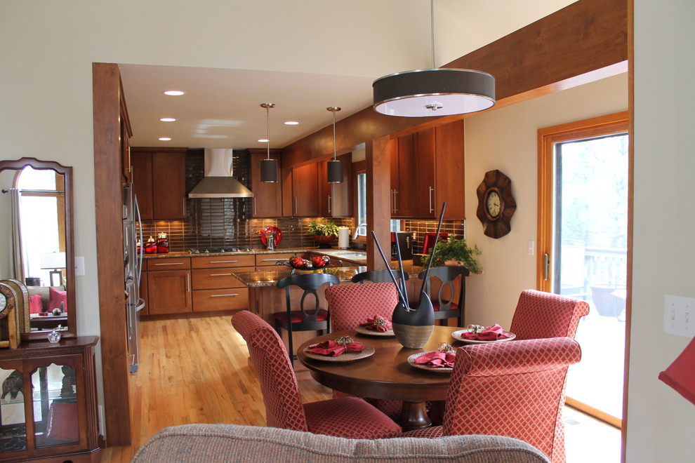 Eat-in kitchen - large transitional u-shaped light wood floor eat-in kitchen idea in Denver with an undermount sink, flat-panel cabinets, dark wood cabinets, granite countertops, brown backsplash, glass tile backsplash, stainless steel appliances and a peninsula
