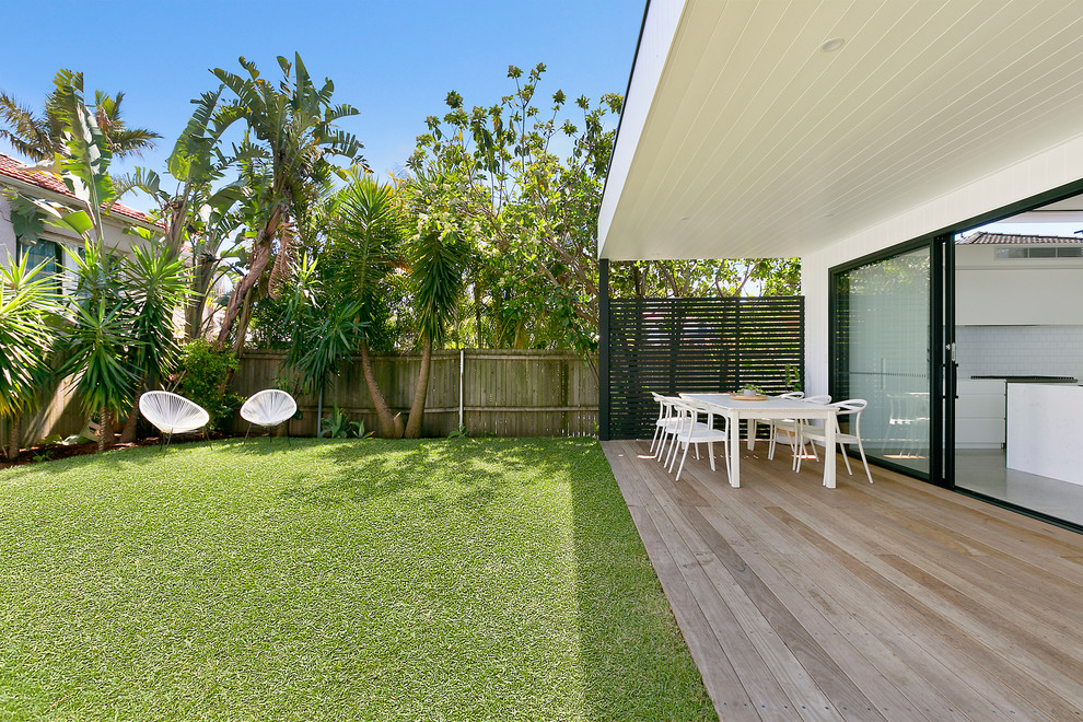 Large contemporary backyard patio in Sydney with a roof extension.