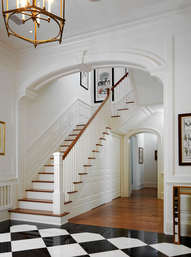Design ideas for a traditional wood staircase in Tampa with painted wood risers and wood railing.