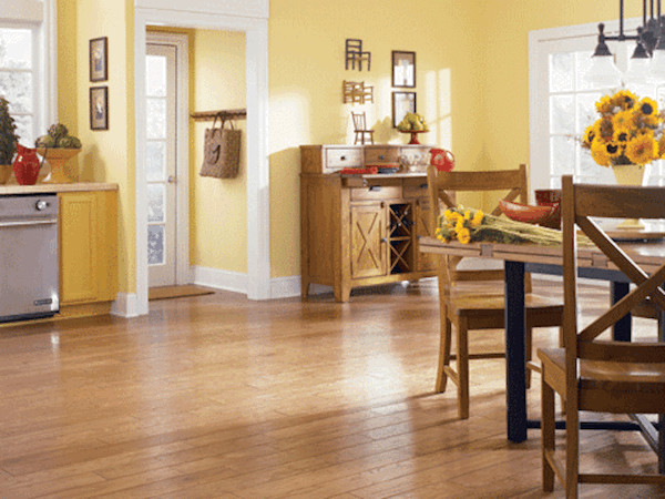 Mid-sized transitional light wood floor eat-in kitchen photo in Cincinnati with yellow cabinets and stainless steel appliances