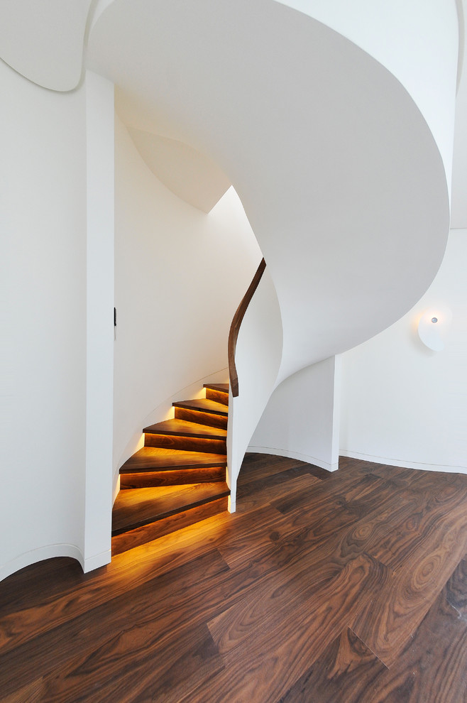 Inspiration for a contemporary wood staircase in London with wood risers.