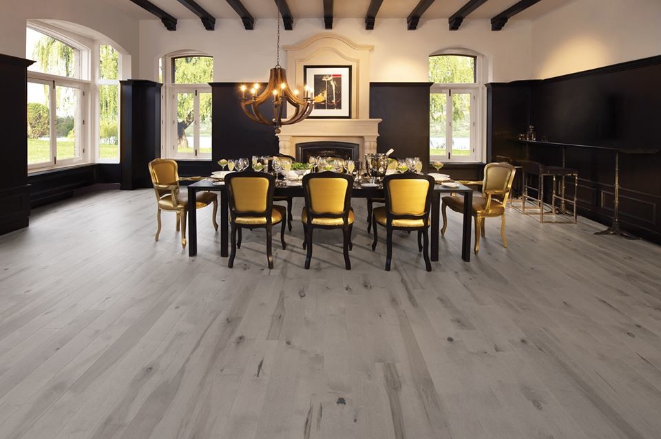 Large traditional separate dining room in Other with multi-coloured walls, porcelain floors, a standard fireplace, a plaster fireplace surround and grey floor.