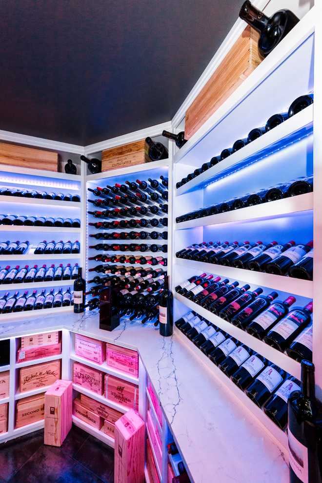 This is an example of a large modern wine cellar in New York with porcelain floors, display racks and multi-coloured floor.