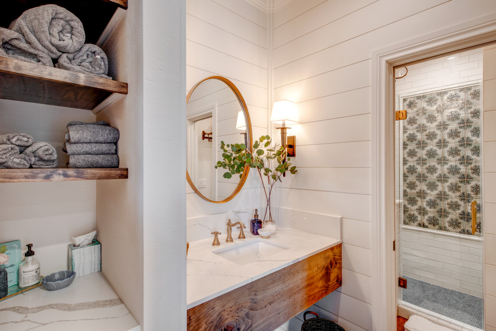Country bathroom in Dallas with medium wood cabinets, a two-piece toilet, white tile, ceramic tile, white walls, porcelain floors, an undermount sink, quartzite benchtops, brown floor, a hinged shower door, white benchtops, a single vanity and a floating vanity.