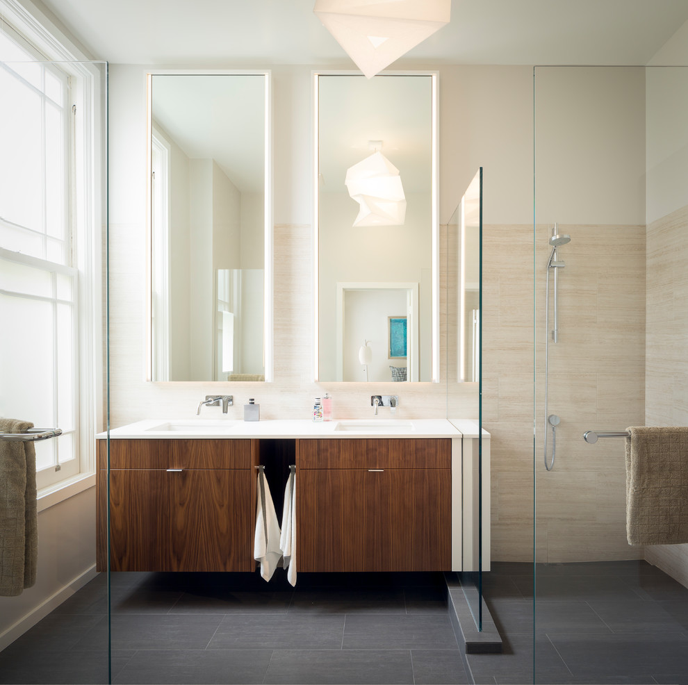 Photo of a mid-sized contemporary master bathroom in San Francisco with flat-panel cabinets, medium wood cabinets, a curbless shower, beige tile, porcelain tile, white walls, porcelain floors, an undermount sink, engineered quartz benchtops, grey floor, an open shower and white benchtops.
