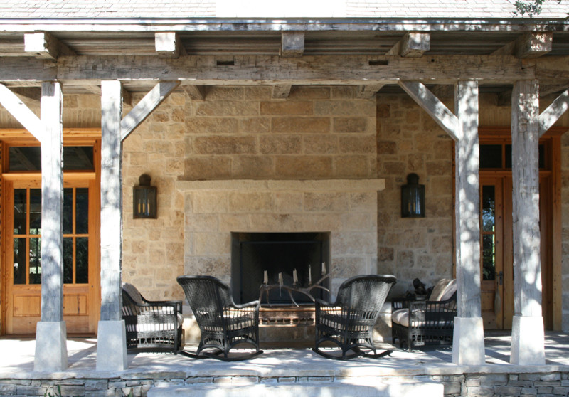 Design ideas for a country patio in Austin with a fire feature and a roof extension.