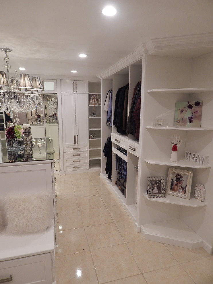 Photo of a large contemporary women's dressing room in Los Angeles with shaker cabinets and white cabinets.