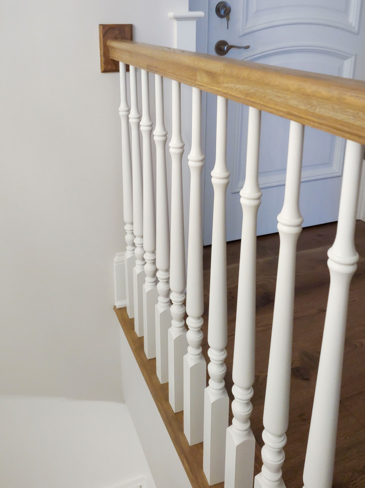 Design ideas for a medium sized traditional wood u-shaped wood railing staircase in DC Metro with painted wood risers and wainscoting.