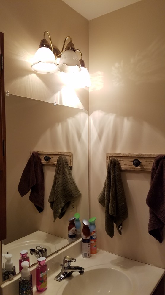 Small mountain style kids' gray tile and porcelain tile porcelain tile and gray floor home design photo with furniture-like cabinets, distressed cabinets, a two-piece toilet, gray walls, an undermount sink, granite countertops and a hinged shower door