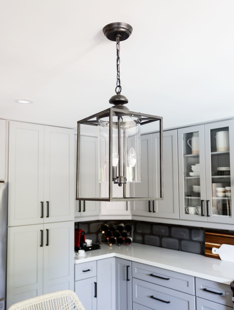 Eat-in kitchen - mid-sized transitional u-shaped light wood floor and gray floor eat-in kitchen idea in Phoenix with an undermount sink, recessed-panel cabinets, gray cabinets, quartz countertops, multicolored backsplash, ceramic backsplash, stainless steel appliances, an island and white countertops