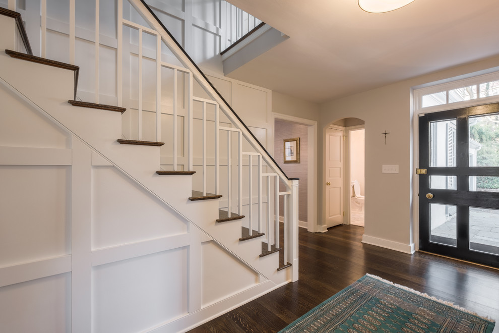 This is an example of a large transitional wood staircase in Philadelphia with wood risers.