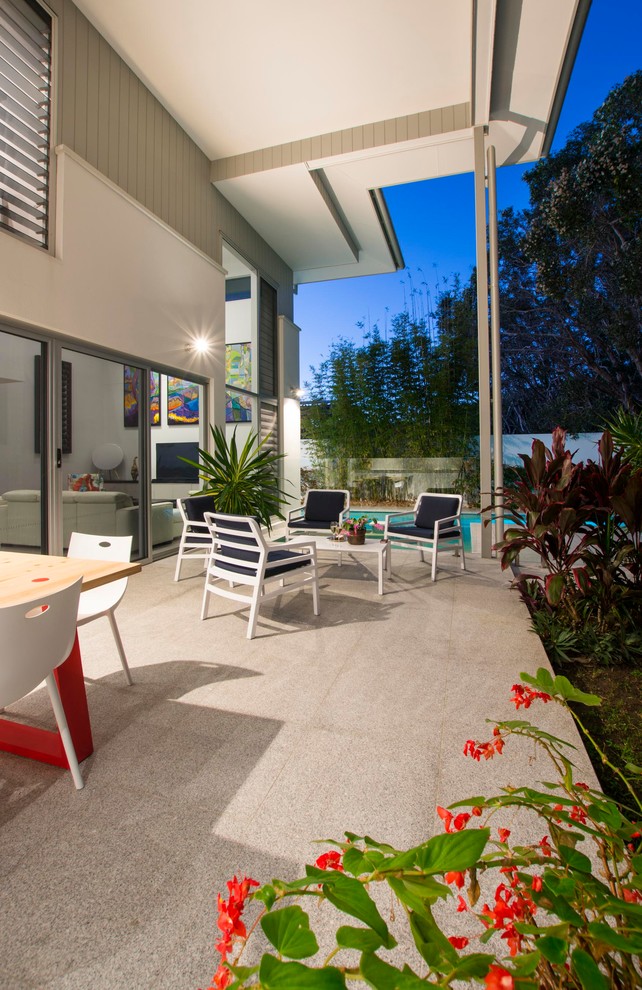 Photo of a beach style patio in Sunshine Coast with a roof extension.
