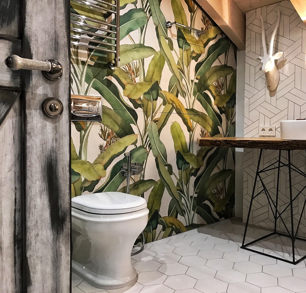 Design ideas for a mid-sized industrial powder room in Moscow with a wall-mount toilet, white tile, glass tile, grey walls, ceramic floors, a drop-in sink, wood benchtops, white floor and beige benchtops.