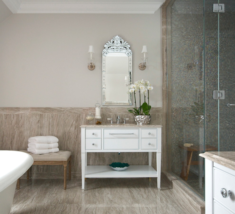 Inspiration for a large bathroom in Montreal with an undermount sink, white cabinets, a freestanding tub, a corner shower, a one-piece toilet, beige tile, beige walls, travertine floors and flat-panel cabinets.
