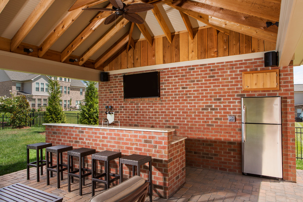 Photo of a mid-sized traditional backyard patio in Charlotte with an outdoor kitchen, brick pavers and a gazebo/cabana.
