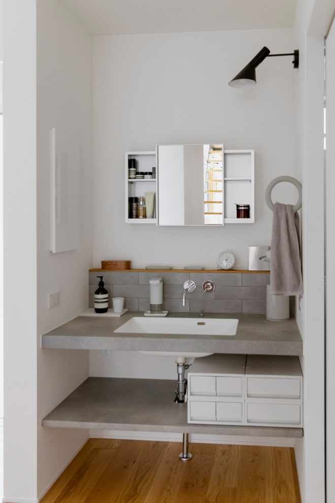 Design ideas for a small scandi cloakroom in Other with open cabinets, grey cabinets, a two-piece toilet, grey tiles, porcelain tiles, concrete worktops, grey worktops and a floating vanity unit.