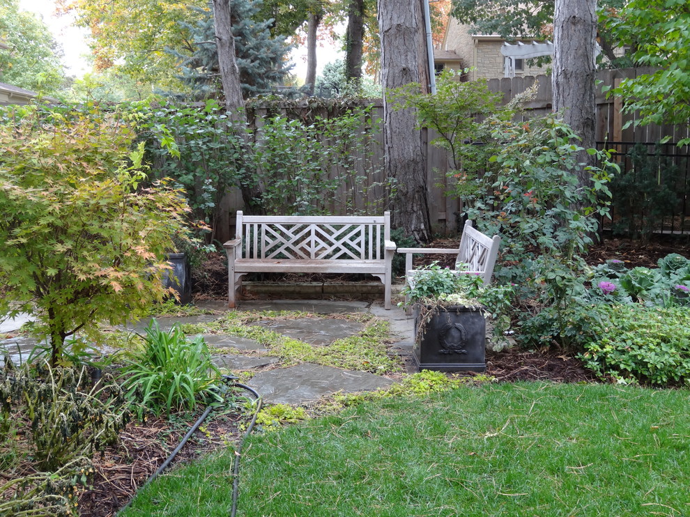 Mid-sized transitional backyard partial sun formal garden in Omaha with natural stone pavers for fall.