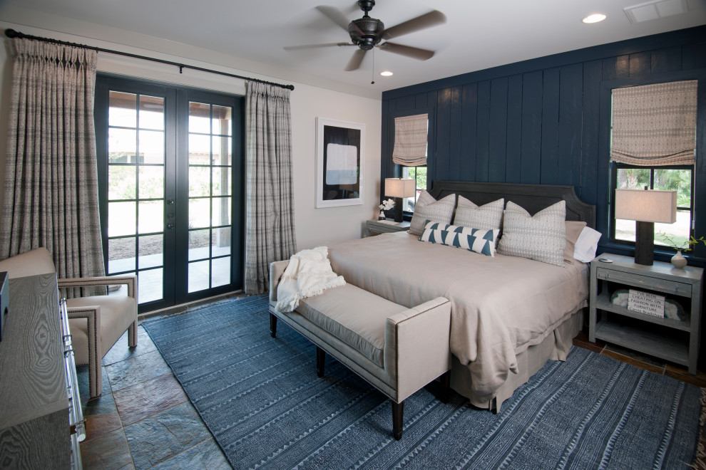 На фото: спальня среднего размера в стиле кантри с синими стенами, коричневым полом, полом из сланца и панелями на части стены